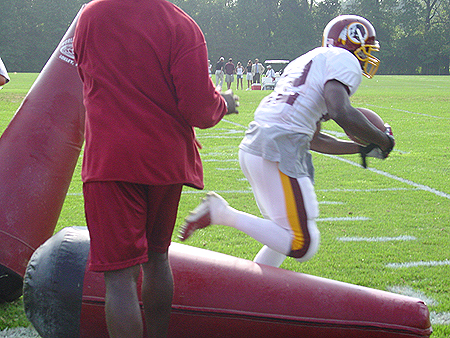 The player runs straight through them up field.