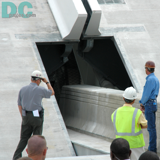 Bridge construction personel closely monitor the performance of the bridge's hydraulic pumps.