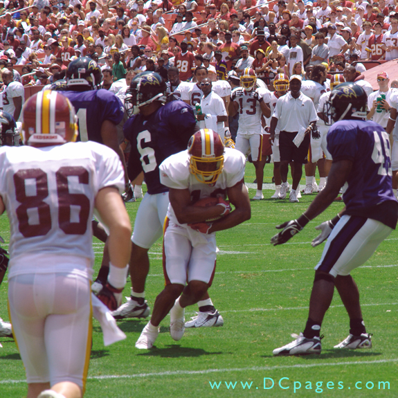 Running hard while cradling the ball like it was a baby.