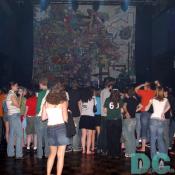 A girl looks at the colorful backdrop, a blow up of Phantom Planet's latest self-titled album cover.