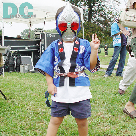 "Peace!" A little boy gave a pose with his favorite cartoon mask. 