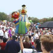 Sesame Street's Burt and Ernie float over the crowd.