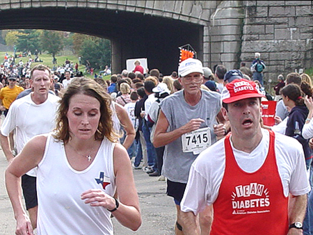 Runners of the 5K look tired towards the end of the race.
