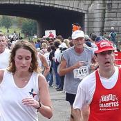 Runners of the 5K look tired towards the end of the race.