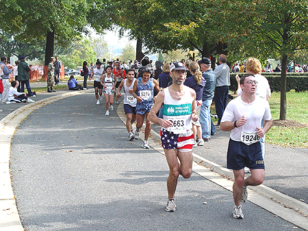 Runners pass through the grounds of the Washington Monument.