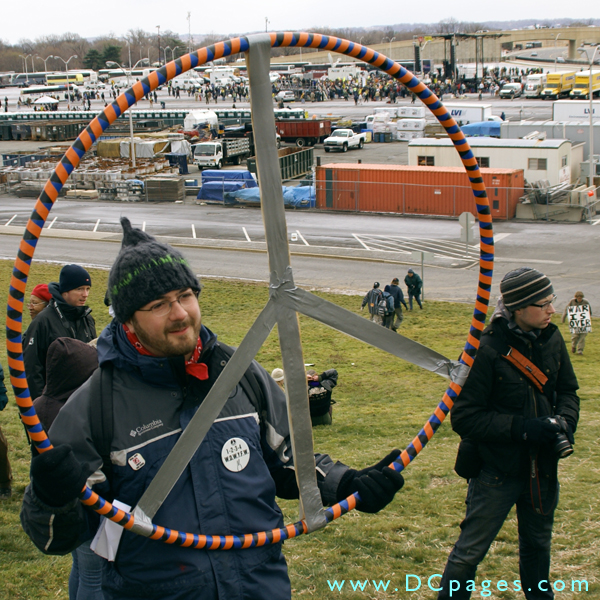 An anti-war protester holds up a peace sign.