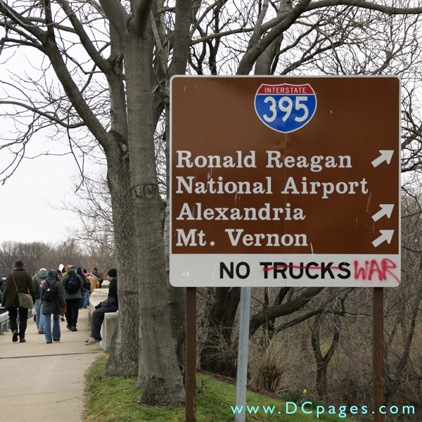 Anti-war graffiti on street sign. The word truck is sprayed over with paint