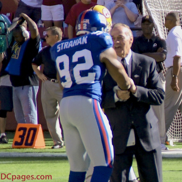 Giants number 92 and Sam Huff shake hands.