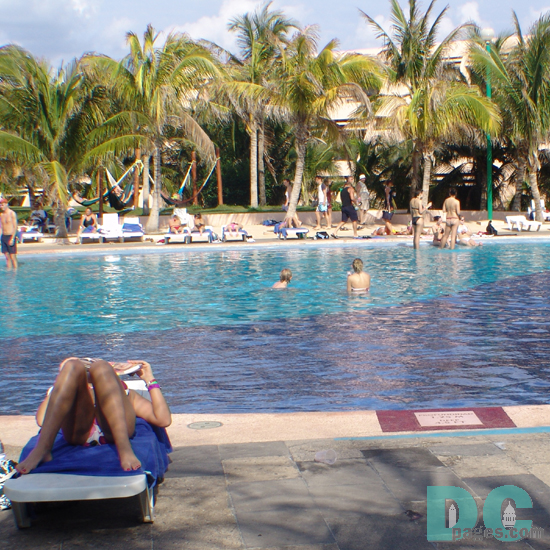 sun bathing at the Oasis Hotel pool.