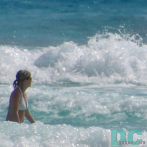 hot blonde girl playing in the caribbean surf