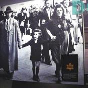 Shows how the Jewish were required to wear these yellow stars to show everyone that they were Jewish.