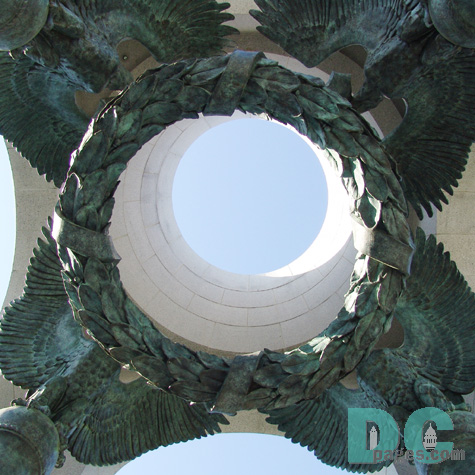 Four bronze American eagles circle over a suspended victory laurel to memorialize the victory of the WWII generation.
