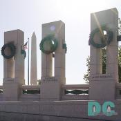 East to West view of granite pillars. American flag and Washington Monument in the background.
