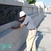 Mason Antonio cleans off excess granite.