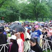 Crowded in the rain, runners patiently wait to begin the race