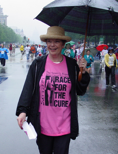 With a big umbrella and a big smile, this survivor walks the race