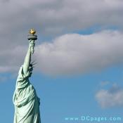 The Statue's copper has naturally oxidized to form its familiar "patina" green coating.  This patina is as thick, in many places, as the copper behind it and is protecting the copper from naturally wearing away. 
