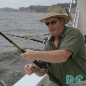 Jerry Rogers just takes it easy and slowly reels his bait in.