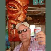 A bust of Ayumma Yumma (the god of tasty rockfish), smiles down on Chris as he toasts his special day to the King of Beers. 