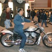 My personal favorite Harley, the 2004 VRSCB V-Rod, it has a v-twin, black frame, stainless steel finish to it's body work, and adjustable handlebars.