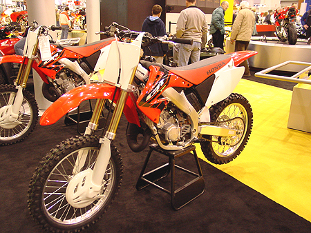 2004 CR250R is a 249cc liquid-cooled single-cylinder two-stroke with electronically controlled RC valve. Meet the only machine ever to go undefeated in the AMA National 250cc Motocross Championship.