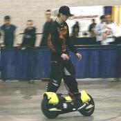 One of the three brothers warming up on a powered foot cruiser before the premiere of The Ball of Steel Stunts Demo.