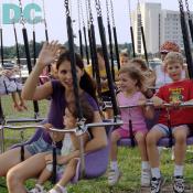 Mothers and children loved going around and around on the amusement ride.