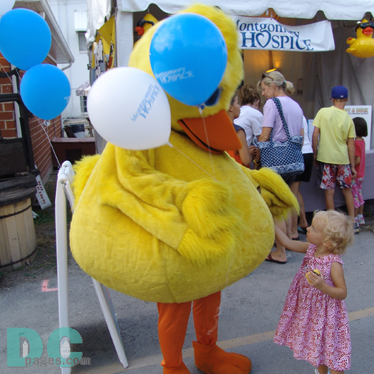 A little girl loves playing with the Hospice ducky.