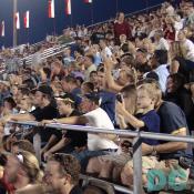 The crowd watches nervously at a monster truck accident.