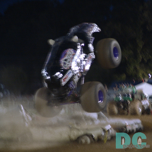 The Engines rev high with big knobby tires spinning over a line of parked junk cars.