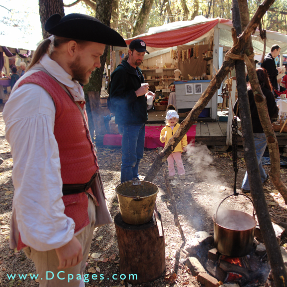 Kevin Summers watches the dye pot as it simmers over a fire.