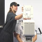Capitals strength coach, Jim Fox, programming Michael Nylander's upper body drill.