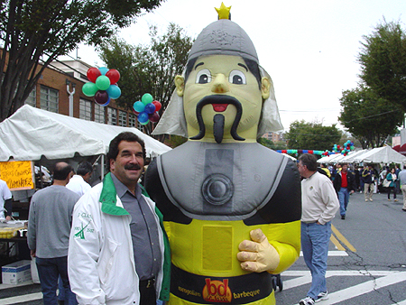 Michael Glickman, of Rockville, Maryland, spends time with the Mongolian Barbeque mascot before testing out the food.