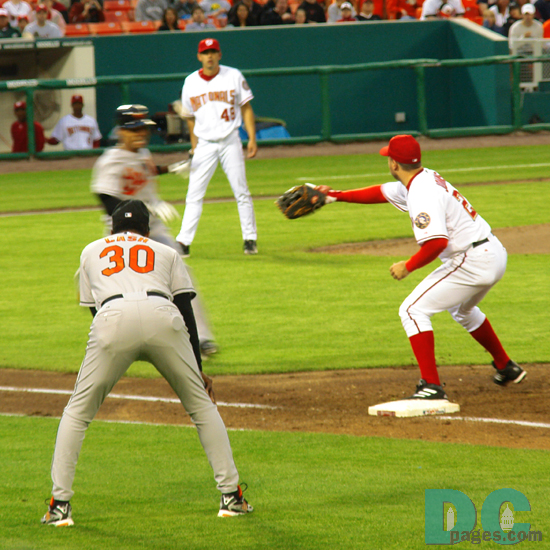Washington Nationals 1B Nick Johnson awaits the throw to first.