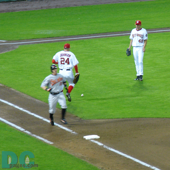 Nationals 1B Nick Johnson and P Mike O'Connor can only look at each other while the Orioles advanced baserunners. 