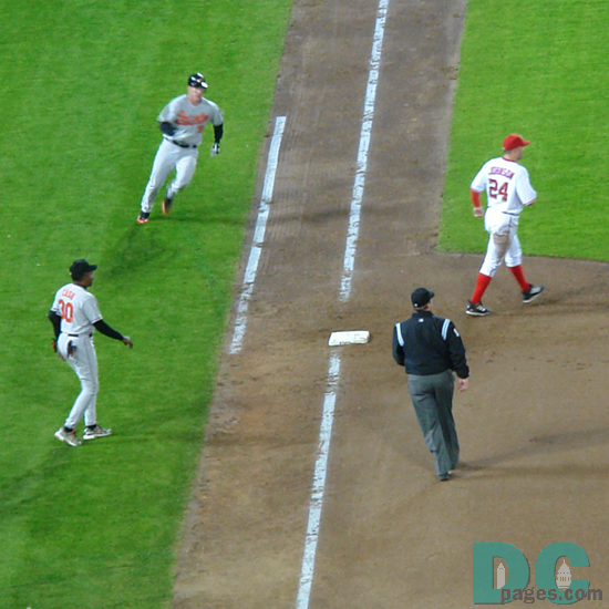 Another hit by the Baltimore Orioles. Washington Nationals Nick Johnson can only look on in frustration.
