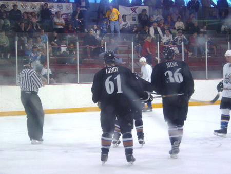 Libby and Mink skate up to the face off.