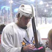 Sutherby signs autographs for fans.