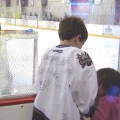 This CAPS fan showing his sister all of his autographs.