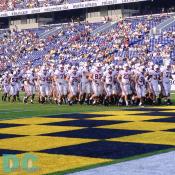 Stanford's football team marches out to the field.