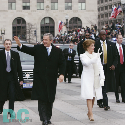 Emerging from their armored limousine, President George W. Bush and first lady Laura Bush wave to well wishers as they prepare to travel 1.7-miles along the inaugural parade route.