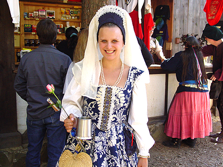 A very beautiful dress, she must be royalty at the festival.