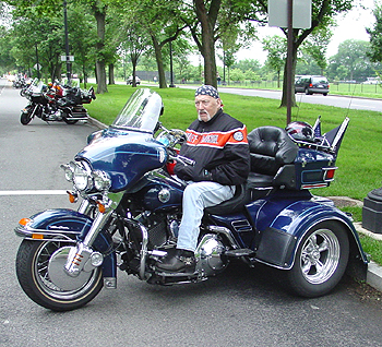 A blue 3 wheeled Harley Davidson.