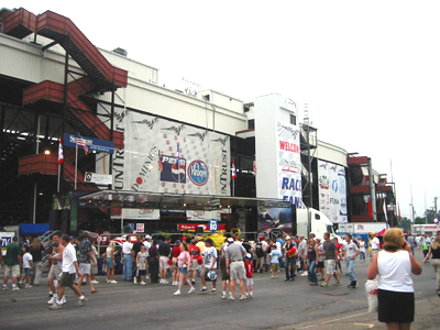 Outside the track, crowds filter in and out of the Indy Sponsor's tents