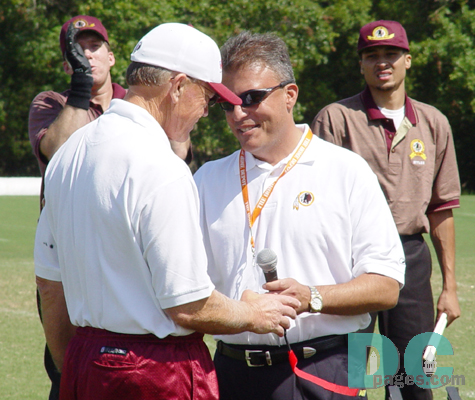 Larry Michael, the new voice of Redskins Radio, hands over the mic to Coach Gibbs.  Gibbs received a thunderous ovation from the faithful.