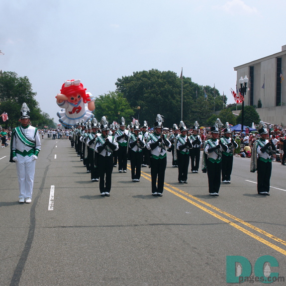 Marching band. Raggedy Ann balloon behind.