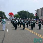 Marching band. Raggedy Ann balloon behind.