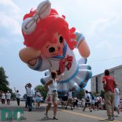 Raggedy Ann balloon. Raggedy Ann is a blue and white clad rag doll with red yarn for hair, created by writer Johnny Gruelle (1880-1938). 