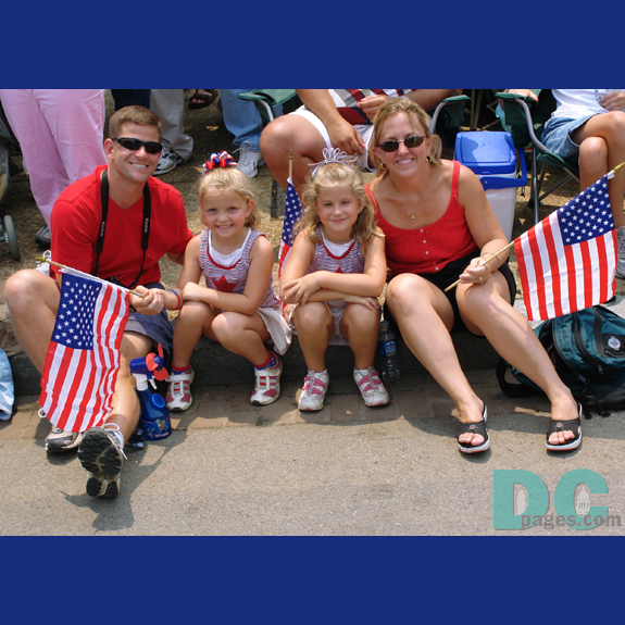 This family is well dressed to watch the parade.