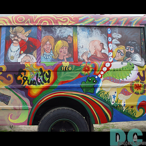 The people are painted in the windows as if they were real riders on the bus.